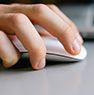 Hand clicking a computer mouse